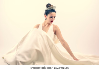 Wow, No Way. Portrait Of Amazed Bride Young Woman In White Dress And Against Light Light Background. Copy Space