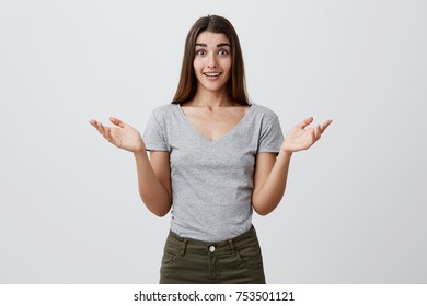 Wow. Positive Emotions. Beautiful Attractive Young Caucasian Woman In Casual Trendy Outfit Smiling, Spreading Hands With Excited Look And Raised Eyebrows, Happy To Know Her Old Friend Got Married