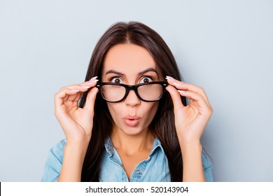 Wow! Shocked Pretty Woman Touching Her Glasses.