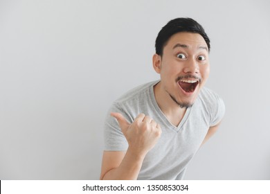 Wow And Surprised Face Of Asian Man In Grey T-shirt With Hand Point On Empty Space.