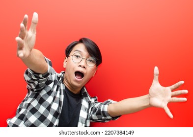 Wow And Surprised Face Of Young Asian Man Feeling Happy, Excited And Positive. Asian Man Open Arms For A Hug And Giving Surprise Gesture.