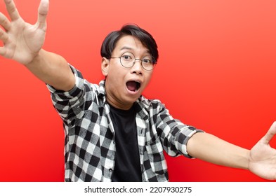 Wow And Surprised Face Of Young Asian Man Feeling Happy, Excited And Positive. Asian Man Open Arms For A Hug And Giving Surprise Gesture. Billboard Advertisment Model Concept.