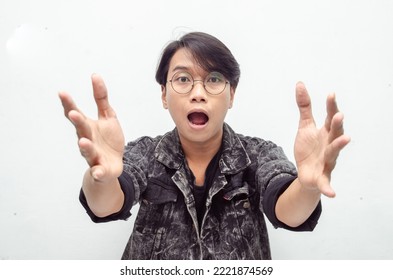 Wow And Surprised Face Of Young Asian Man Feeling Happy, Excited And Positive. Asian Man Open Arms For A Hug And Giving Surprise Gesture. Billboard Advertisment Model Concept.