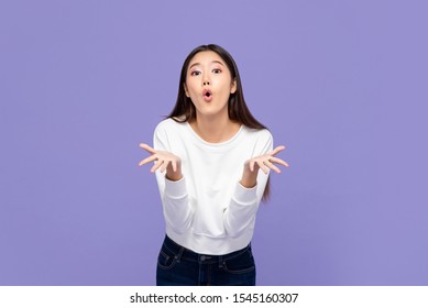 Wow Surprised Young Asian Girl With Both Hands Open Isolated On Purple Background