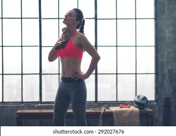 Wow, That Felt Good. A Woman Wipes Hard-earned Sweat Off Her Neck After A Great Workout.