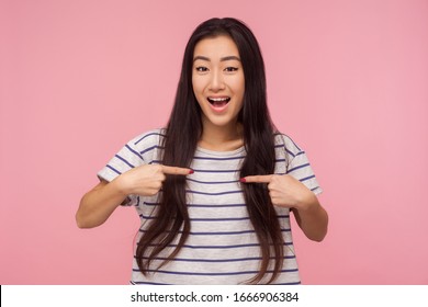 Wow, this is me! Amazed attractive girl with long hair pointing herself and looking with surprised expression, proud of own success, self-love concept. indoor studio shot isolated on pink background