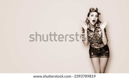 WOW! Unbelievable breaking news! Excited surprised, very happy yelling woman. Pin up girl with open mouth and raised rising hands. Retro vintage concept. Brown toned monochrome bw photo.
