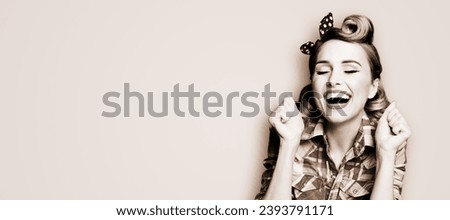 WOW! Unbelievable news! Excited surprised very happy rockabilly woman. Astonished pinup girl open mouth, closed eyes raised rising hands fists. Retro vintage concept. Brown toned monochrome bw photo.
