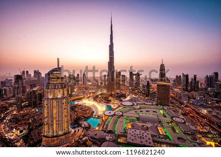 WOW view of Dubai skyline at night. City lights popping. Dancing fountain display. Luxury travel holiday concept.  