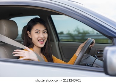 Wow. Young Beautiful Asian Women Getting New Car. She Very Happy And Excited. She Sit And Touching Every Detail Of Car. Smiling Female Driving Vehicle On The Road