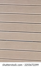 WPC Wood Plastic Composit Deck Texture. Decking board, diagonal laying. New sanded wooden garden decking. Vertical