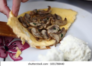 Wrap Fried Champignon Mushrooms In Omelette