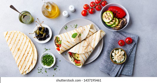 Wrap Sandwich With Grilled Vegetables And Feta Cheese On A Plate. Grey Background. Top View.