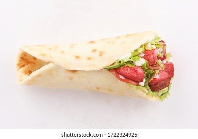 wrap sandwich naan bread tandoori paprika with salad isolated top view on white background