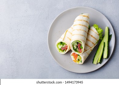 Wrap Sandwich, Roll With Fish Salmon And Vegetables. Grey Background. Close Up. Top View.