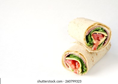 Wrap Sandwich With Salami, Lettuce, Tomatoes And Cheeses On White Background With Copy Space.