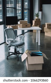 Wrapped Chair And Cardboard Boxes In Office During Relocation