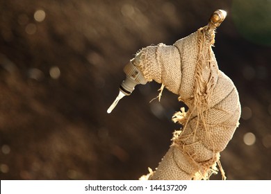 Wrapped Up Garden Tap With Frozen Drop Of Water.