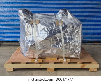 Wrapped Goods Securely Placed On Top Of A Wooden Pallet. 