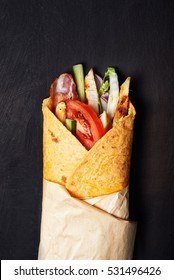 Wrapped Sandwich With Chicken Over Dark Background. Top View