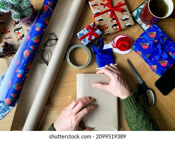 Wrapping Christmas Present. Wrapping Up With Craft Paper. Man Is Wrapping Christmas, New Year Or Birthday Presents. Wrapping Paper And Ribbon View From Above. Step By Step Instruction. DIY