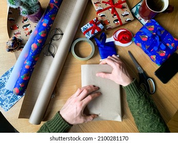 Wrapping Christmas Present. Wrapping Up With Craft Paper. Man Is Wrapping Christmas, New Year Or Birthday Presents. Wrapping Paper And Ribbon View From Above. Step By Step Instruction. DIY