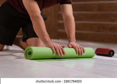 Wrapping Up Roll Mat Athletic Man, Cleaning A Place For Sports. Determined Guy Doing Physical Training. Strong Handsome Young Man, An A Gym. 