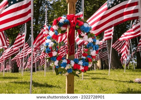 Wreath among 777 American flags in Campagnone Common across from City Hall commemorating service members killed in action from Lawrence.