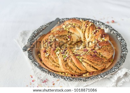 Wreath Bread on vintage tray with pistachio filling on light background