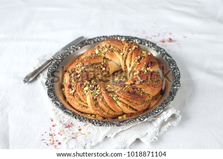 Wreath Bread on vintage tray with pistachio filling on light background