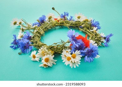 Wreath of chamomile flower on green background. Midsummer holiday background - Powered by Shutterstock