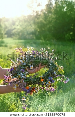 Similar – Woman making wild flowers at home in vase