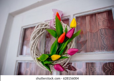 Wreath Of Pink, Red And Yellow Tulips. Spring Decoration On The Wooden Door Of The House