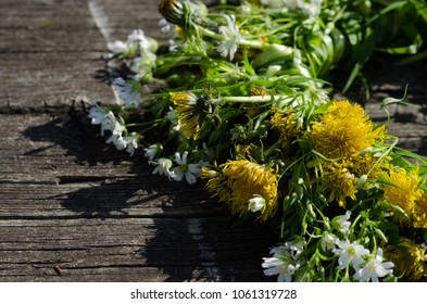Wreath of spring yellow flowers on a wooden board, texture, background, wallpaper
