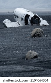 Wreck Of And Airplane Rear View With Huge Stones