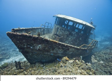 The wreck of the Mr. Bud, a former shrimping boat, scuttled off the island of Roatan, Honduras and now used as a scuba diving site. - Shutterstock ID 89294479