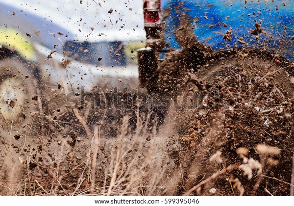 Wreck scrap cars dirt race. Selective focus on\
splashing mud