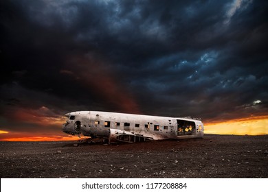wreck of a white airplane on the black beach of Vik at sunset
