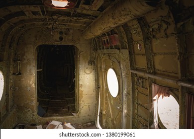 Wreckage aircraft interior. Scary view, old airplane lost at time. Destroyed propeller plane on the field