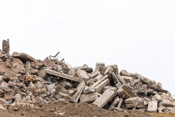 The Wreckage Of A Destroyed Building Isolated On A White Background. Pieces Of Concrete Walls, Steel Reinforcement And Fragments Of Cement. Building Demolition Or Collapse Concept. Copy Space