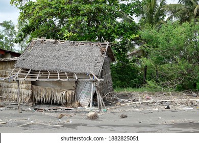 Wrecked Bamboo Hut, Driftwoods And Ocean Debris Along Sea Shore