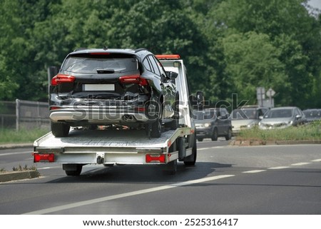 Wrecked car being towed by roadside service