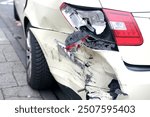 wrecked car close-up, severely damaged car after car accident, Huge dent in car body, reckless driving, reminder about insurance