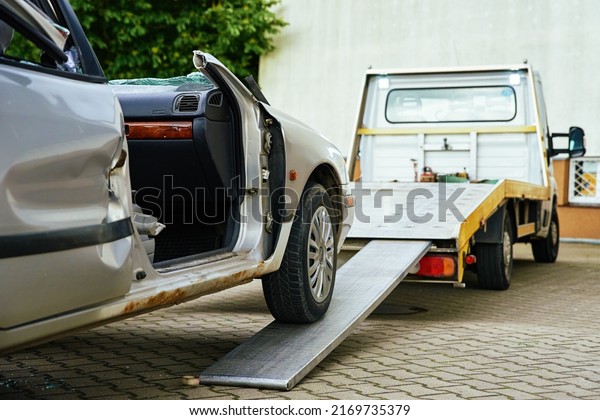 Wrecked car loading on tow truck after crash\
traffic accident, Concept of dangerous driving after drinking\
alcohol, Roadside assistance\
concept