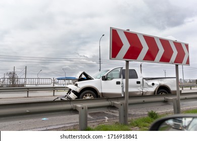 Wrecked Car Pickup Truck Crash Accident On Highway City Road. Damaged Big White Vehicle After Collision Accident Waiting For Police And Towing Truck