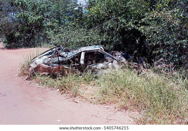 A wrecked and junk car in\
Africa