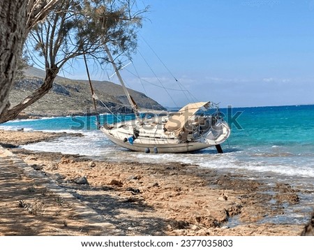 Wrecked sailboat on a rocky coast in Greece.

