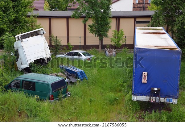Wrecks of passenger cars and a truck with a trailer
in the grass