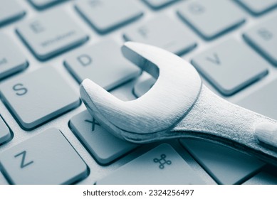 Wrench spanner on keyboard background. Customer online service center for troubleshooting quick support warranty claim concept. Computer technology product, laptop, desktop, notebook, online internet.