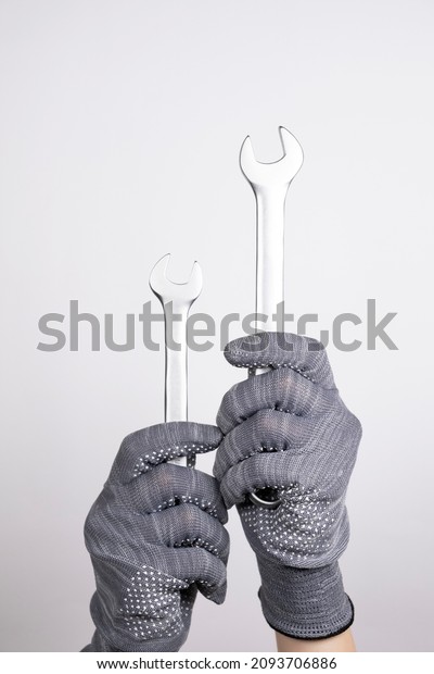 Wrenches in hands on a white background. Wrenches
upright on a white background. Car service, equipment repair,
sewerage repair